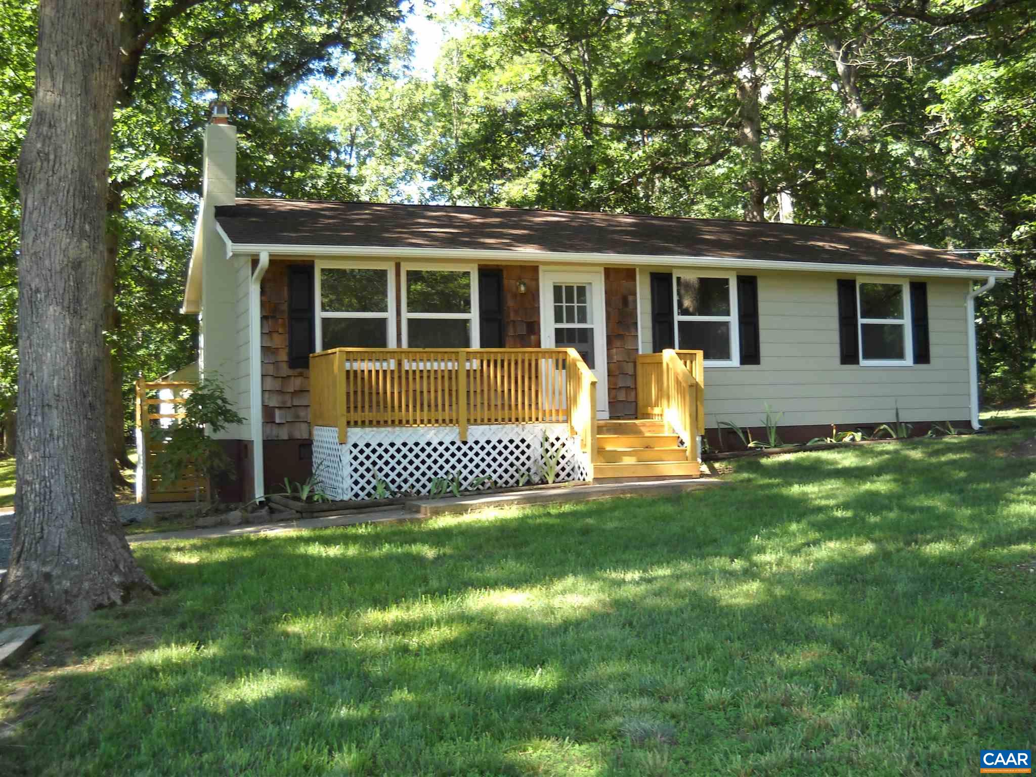 a view of a house with a yard and porch