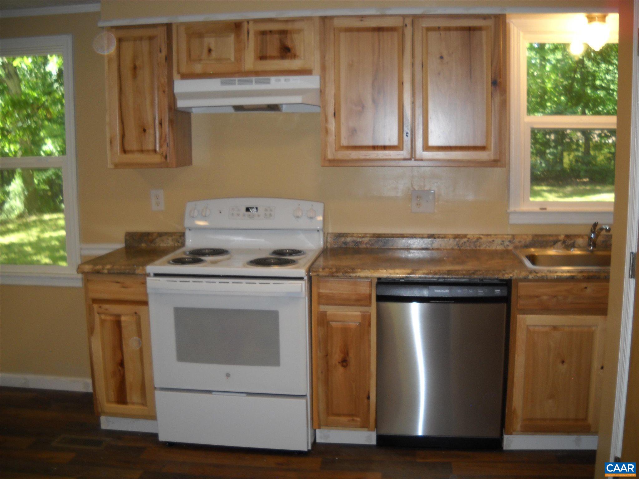 191 Stage Coach Hills Road Palmyra, VA 22963 - Photo 4 of 5 a kitchen with granite countertop cabinets stainless steel appliances and a window
