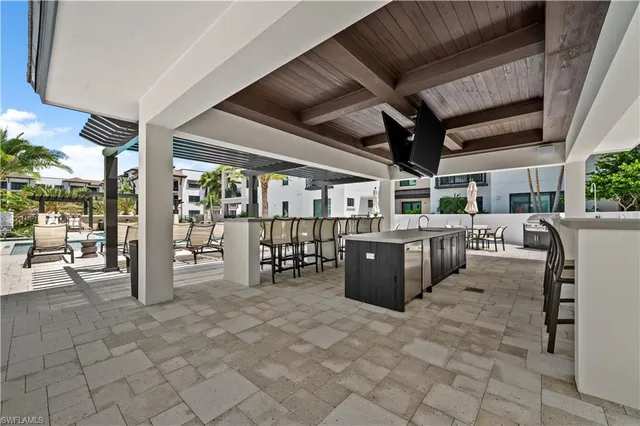 a view of a patio with table and chairs