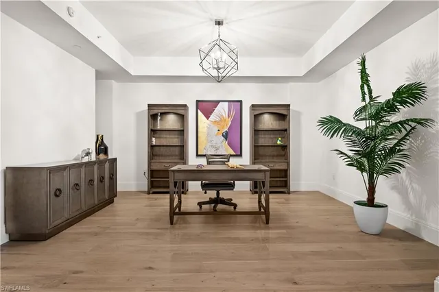 a view of a room with furniture wooden floor and windows