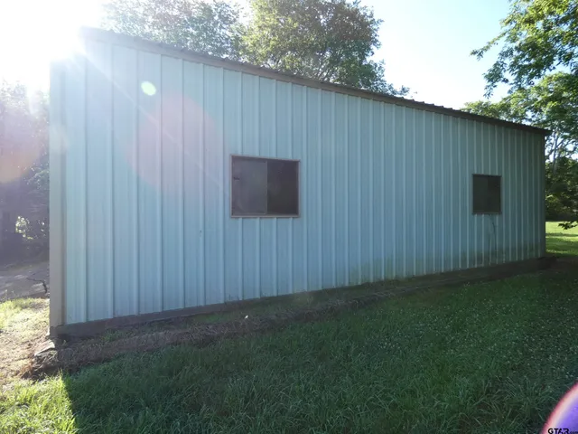 a backyard view with hardwood wall