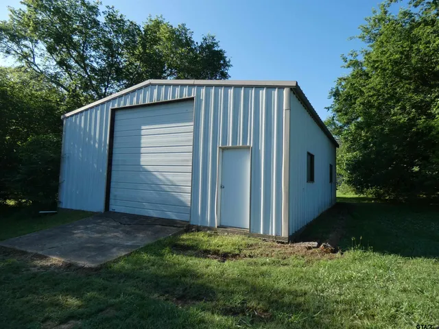 a view of backyard of house and yard