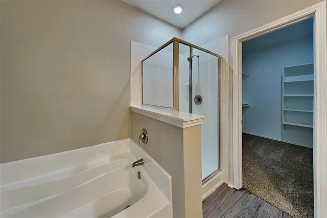a bathroom with a bathtub and a shower