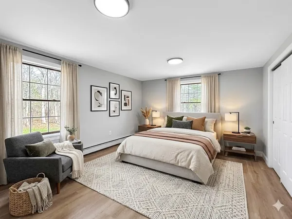 a spacious bedroom with a bed and wooden floor