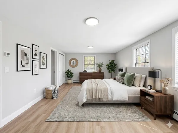 a bedroom with a large bed and wooden floor