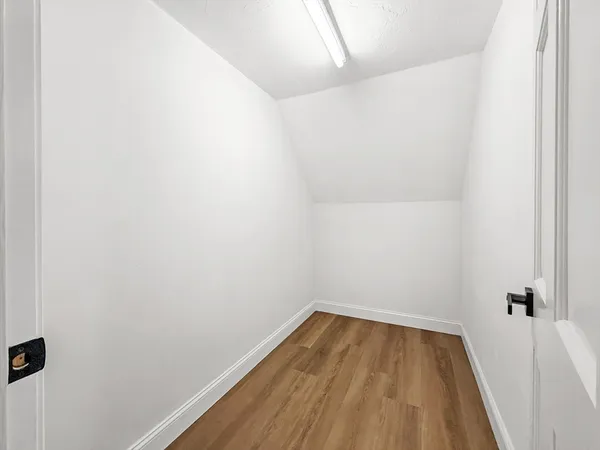 a view of a room with wooden floor