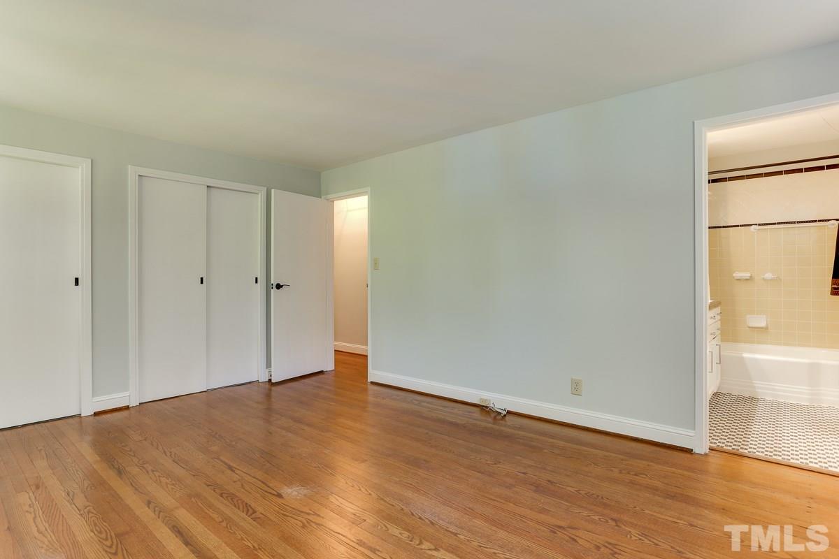2413 Beechridge Road Raleigh, NC 27608 - Photo 14 of 25 a view of an empty room with wooden floor