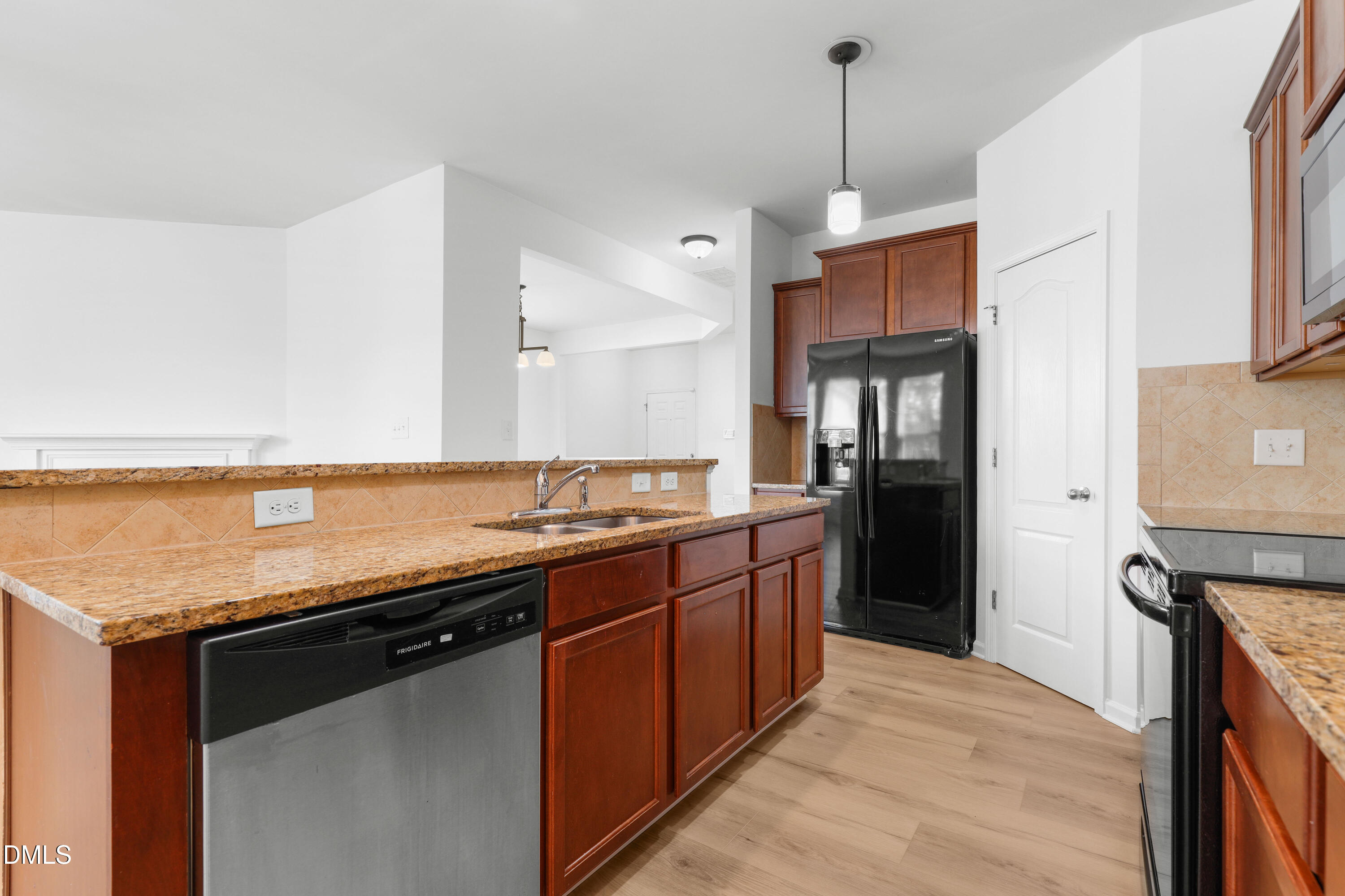 4400 Hillsgrove Road Wake Forest, NC 27587 - Photo 7 of 49 a kitchen with stainless steel appliances granite countertop a sink a stove and a refrigerator