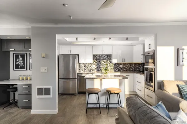 a kitchen with a sink stove and cabinets