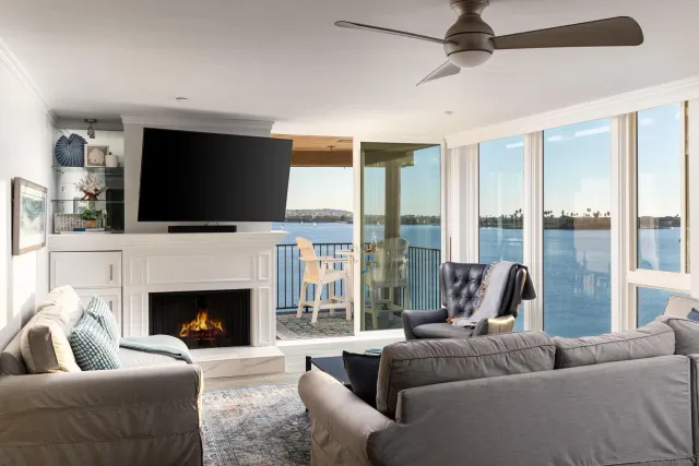 a living room with furniture wooden floor and a large window