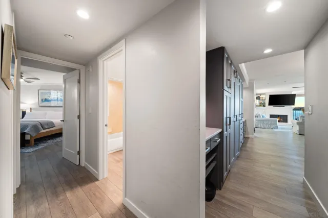 a bedroom with bed and wooden floor