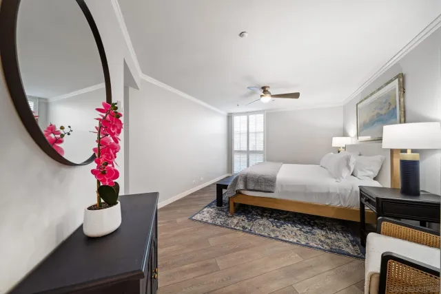 a bedroom with bed and a chandelier