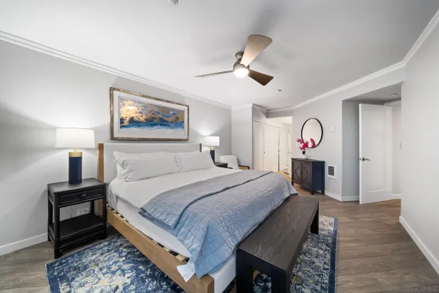 a bedroom with a bed a couch and a window