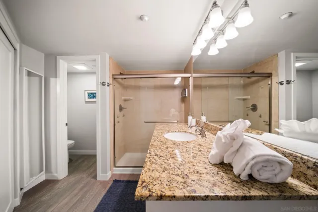 a bathroom with a granite countertop sink mirror and
