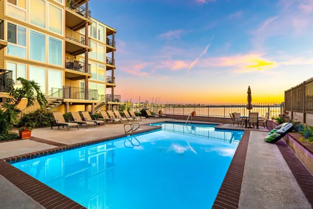a view of a swimming pool with outdoor seating