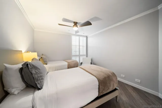 a bathroom with a granite countertop sink toilet mirror and bathtub