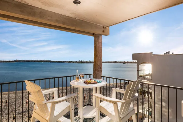 a view of a balcony with wooden floor and outdoor seating