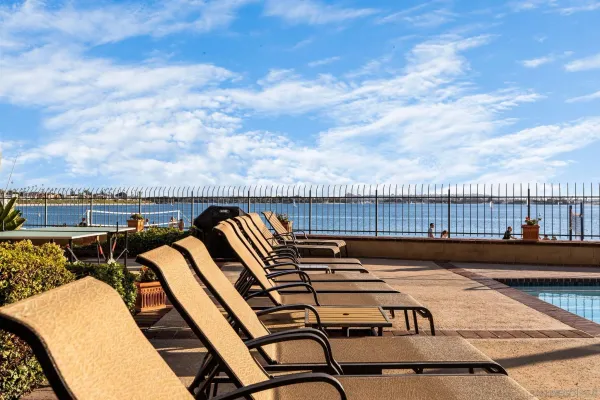 a view of a chairs and table in the balcony