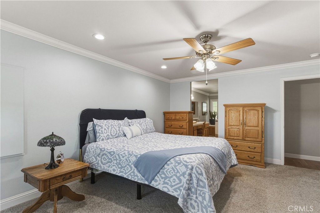 3856 North Gardner Avenue Merced, CA 95340 - Photo 22 of 59 a bedroom with a bed and a chandelier