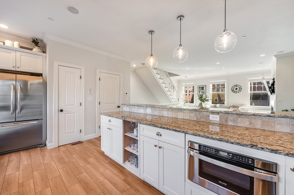 46 Rutherford Avenue Boston, MA 02129 - Photo 11 of 33 a kitchen with stainless steel appliances granite countertop a stove and a sink