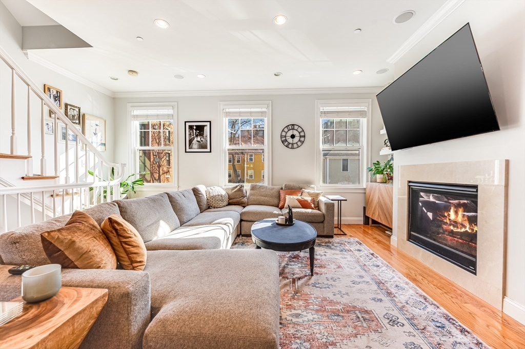 46 Rutherford Avenue Boston, MA 02129 - Photo 4 of 33 a living room with furniture a flat screen tv and a fireplace