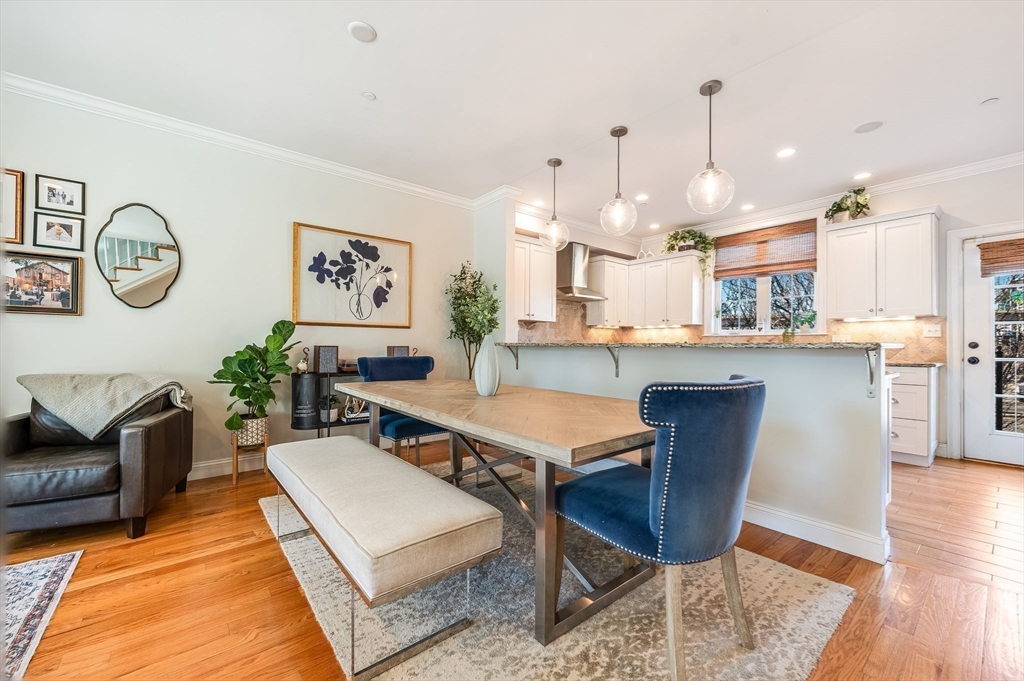46 Rutherford Avenue Boston, MA 02129 - Photo 7 of 33 a living room with dining table and a clock