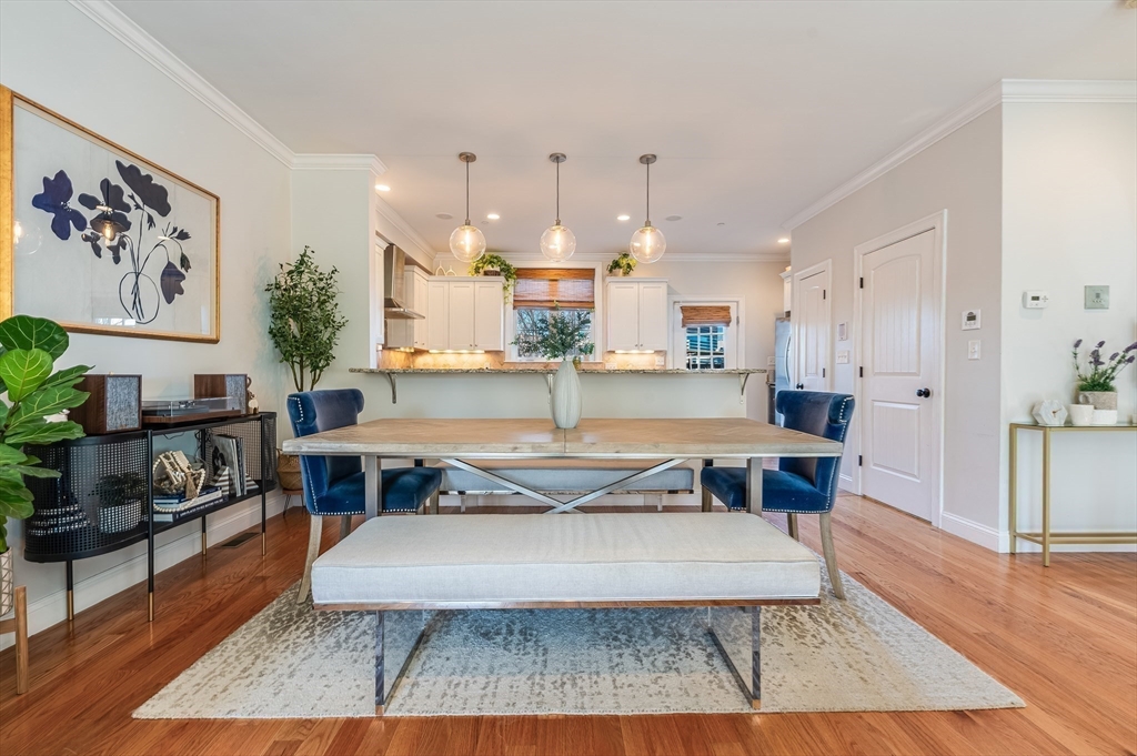 46 Rutherford Avenue Boston, MA 02129 - Photo 8 of 33 a living room with furniture and a dining table with wooden floor