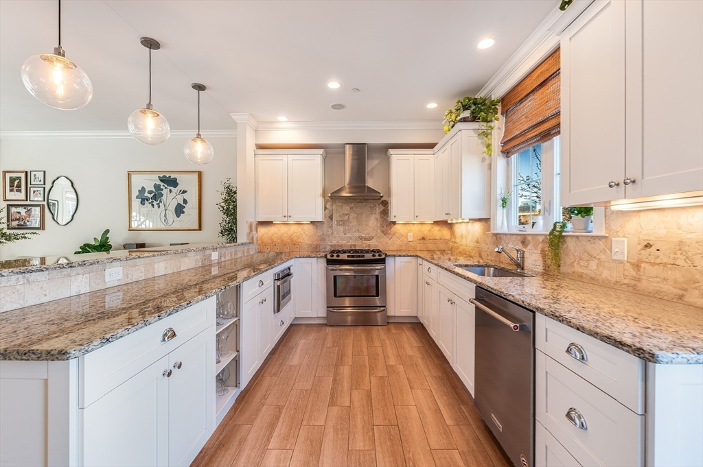 46 Rutherford Avenue Boston, MA 02129 - Photo 10 of 33 a large kitchen with stainless steel appliances granite countertop a lot of counter space and wooden floors