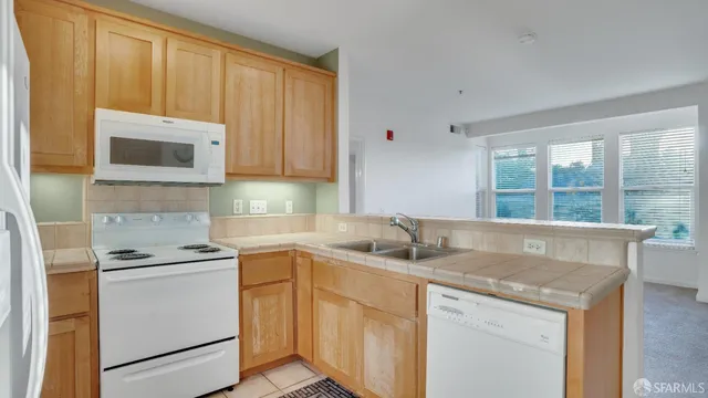 a kitchen with appliances cabinets and a sink