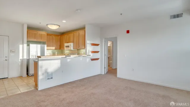 a view of kitchen with wooden cabinets