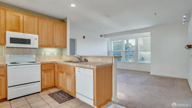 a kitchen with a stove a sink and a microwave