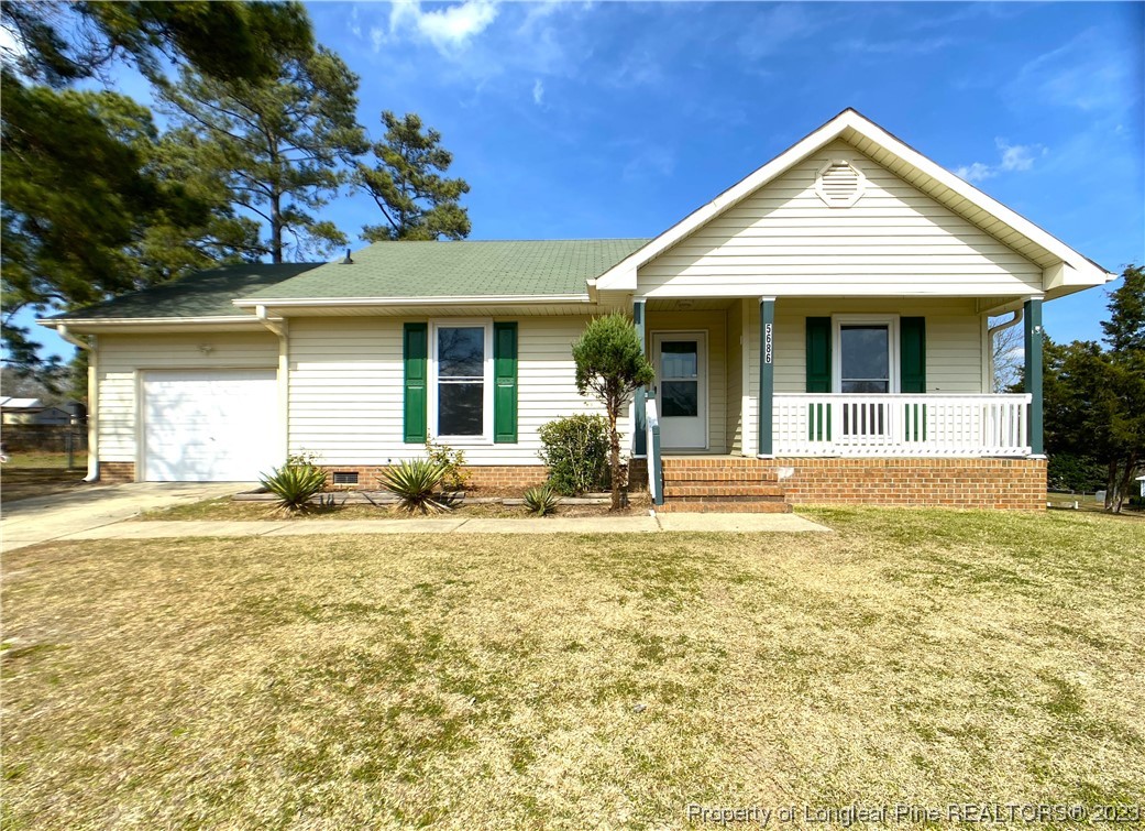 5686 Castleton Drive Hope Mills, NC 28348 - Photo 1 of 21 a front view of a house with a yard outdoor seating and garage