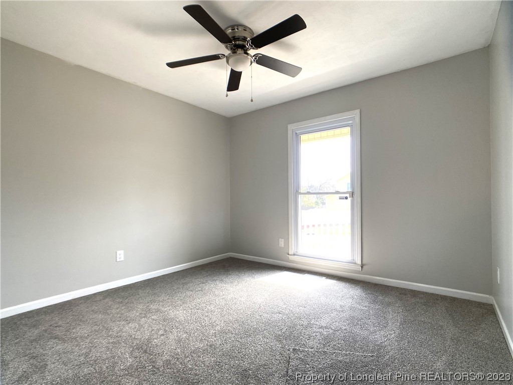 5686 Castleton Drive Hope Mills, NC 28348 - Photo 15 of 21 an empty room with a window and a fan