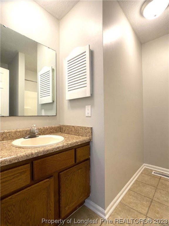 5686 Castleton Drive Hope Mills, NC 28348 - Photo 17 of 21 a bathroom with a granite countertop sink and a mirror