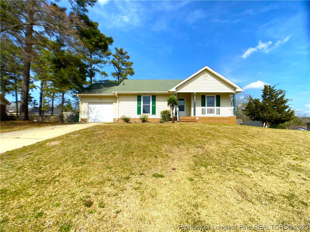 5686 Castleton Drive Hope Mills, NC 28348 - Photo 2 of 21 a front view of a house with a yard