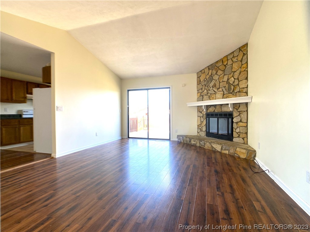 5686 Castleton Drive Hope Mills, NC 28348 - Photo 3 of 21 an empty room with wooden floor fireplace and windows