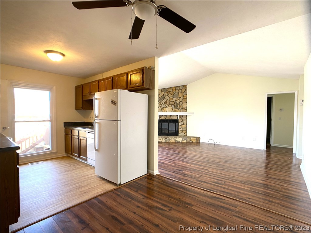 5686 Castleton Drive Hope Mills, NC 28348 - Photo 4 of 21 a view of a kitchen with wooden floor and a refrigerator