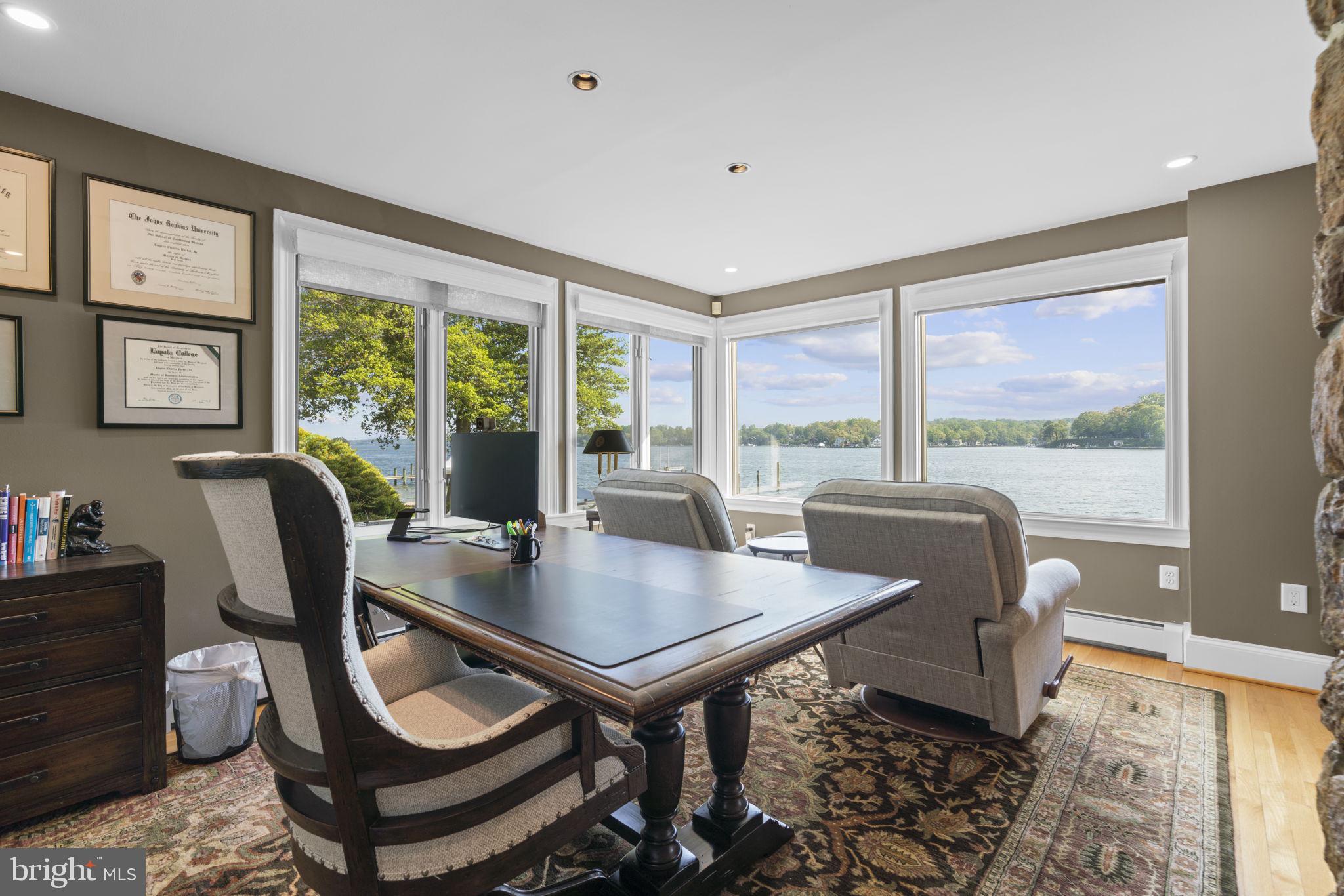 674 Hendler Road Severna Park, MD 21146 - Photo 15 of 48 a view of a dining room with furniture large windows and wooden floor