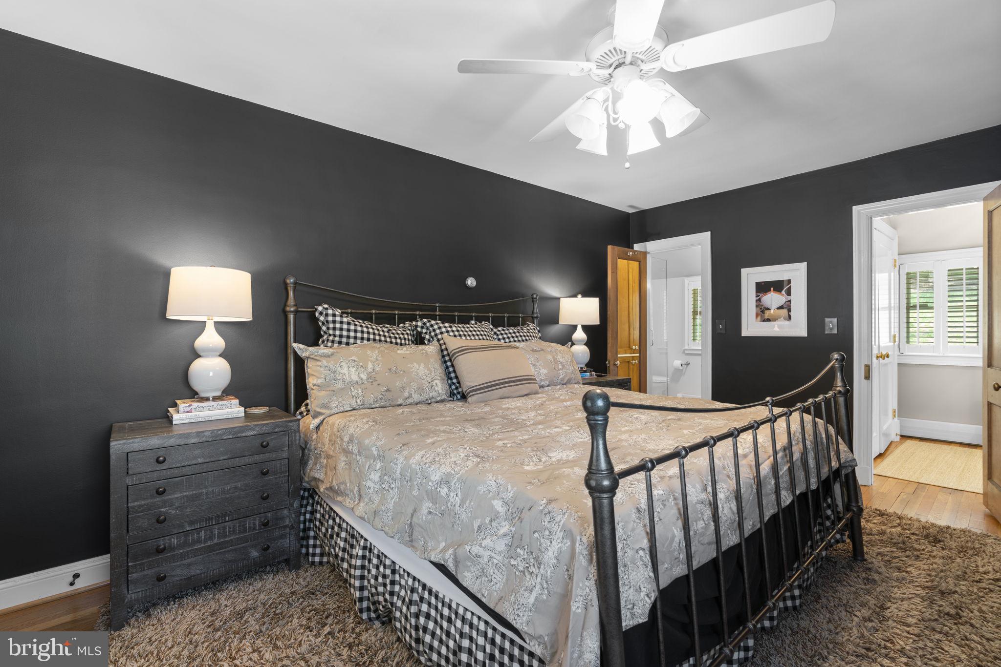 674 Hendler Road Severna Park, MD 21146 - Photo 18 of 48 a bedroom with bed and a chandelier