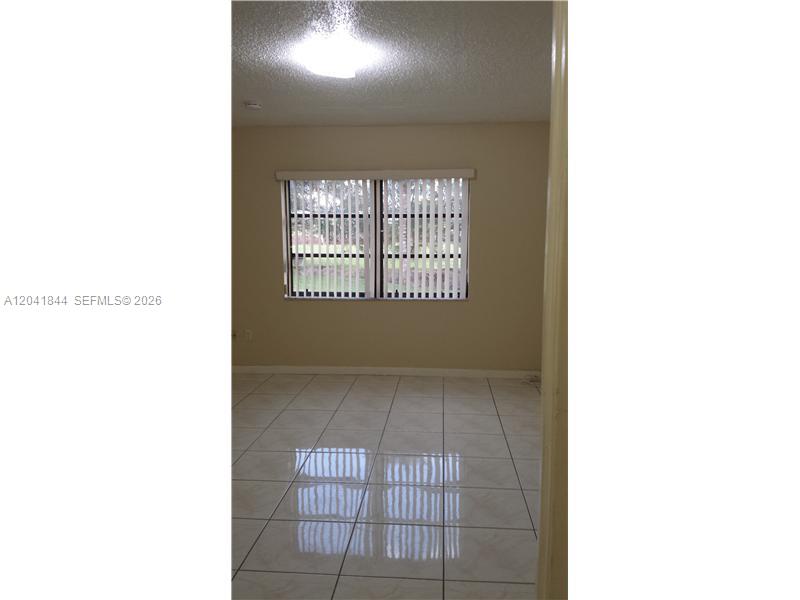 8610 Southwest 149th Avenue, Unit 504 Miami, FL 33193 - Photo 10 of 13 a view of an empty room with a window