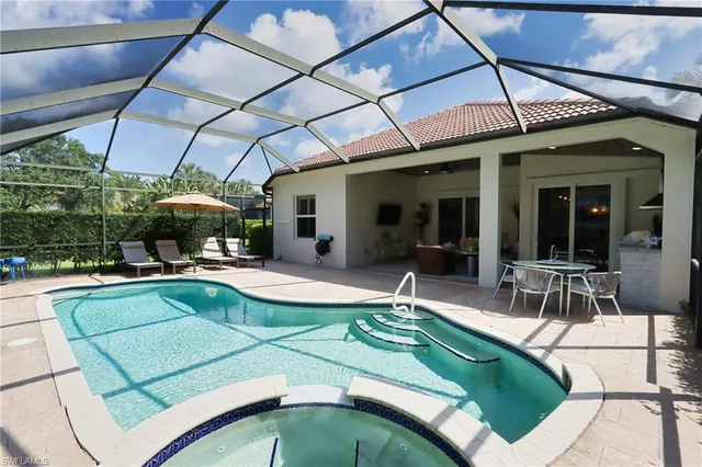 a view of a patio with a table and chairs under an umbrella