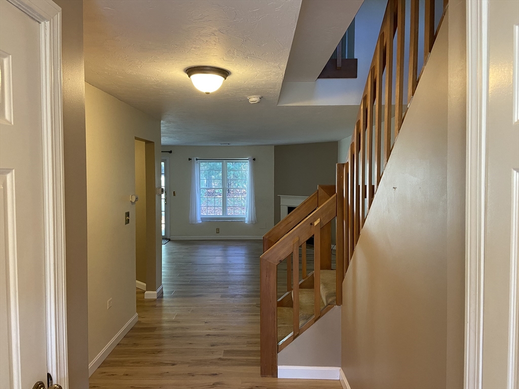 501 Ridgefield Circle, Unit B Clinton, MA 01510 - Photo 2 of 17 a view of an entryway with wooden floor and stairs