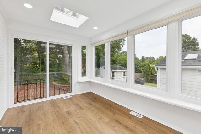 a bathroom with a sink a toilet and a window