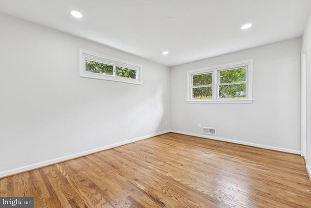 a view of a room with wooden floor and bathroom view