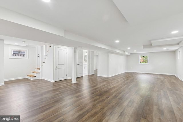 a view of a room with wooden floor