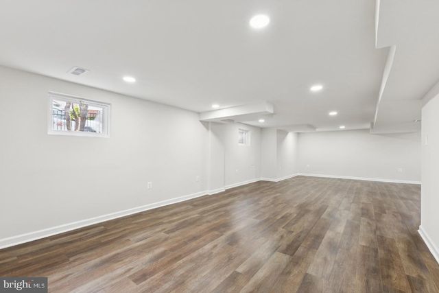 a view of a room with wooden floor and window