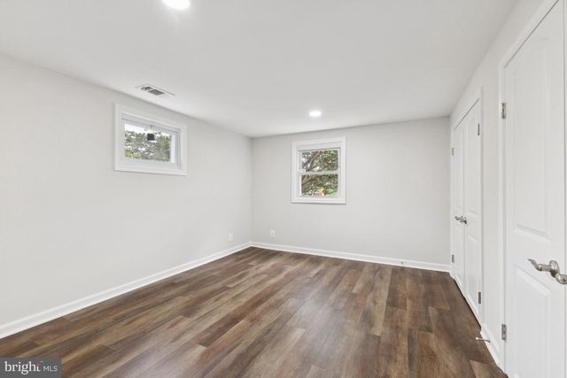 a spacious bathroom with a shower sink and mirror