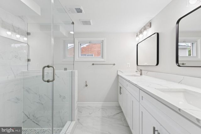 a bathroom with a double vanity sink mirror and double
