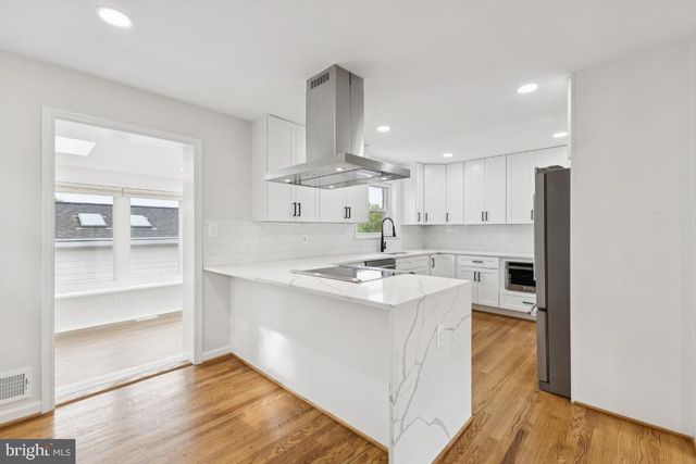 a kitchen with a sink stainless steel appliances and cabinets