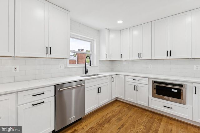 a kitchen with a sink cabinets and stainless steel appliances